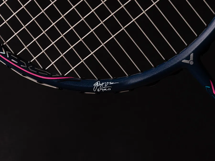 The racket frame is printed with Polii’s signature...
